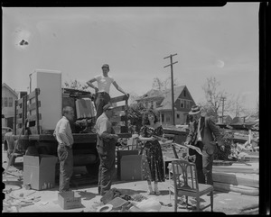 Woman and four men with a truck and household items