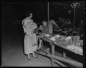 Woman and boy selecting shoes from a clothing drive