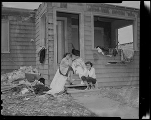 Two women with heads in their hands, sitting on stairs