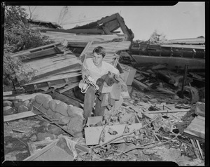 Boy collecting items from wreckage