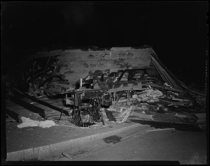 Singer sewing machine in front of collapsed building