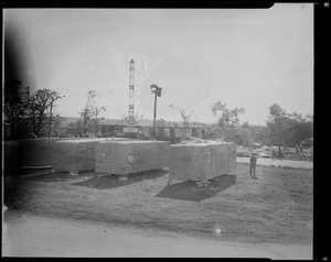 Four mobile homes lined up with a man standing alongside