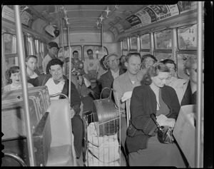 Group of people on a bus with luggage