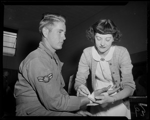 Woman wrapping the hand of a military man