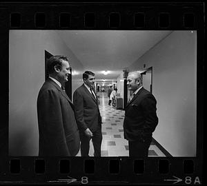 Men in suits talking in hallway