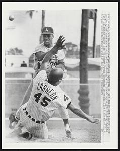 Camilo Carreon of the White Sox slides into 2nd, out, but creates enough of an obstacle to break up a 5th inning double play allowing White Sox pitcher Frank Baumann to reach first ahead of L.A. Dodger shortstop Maury Wills' throw.