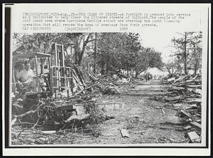 Gulfport, Miss. -- The Clean Up Starts -- A forklift is pressed into service as a bulldozer to help clear the littered streets of Gulfport. The people of the gulf coast area where hurricane Camille struck are starting the giant clean-up operation that will remove the tons of wreckage from their streets.