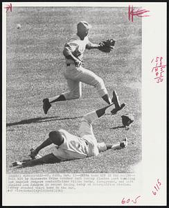 Minneapolis - St. Paul – Extra Base Hit In The Making – Ball hit by Minnesota Twins catcher Earl Battey flashes past tumbling Los Angeles Dodgers center fielder Willie Davis, foreground, and left fielder Lou Johnson in second inning today at Metropolitan Stadium. Battey reached third base on the hit.
