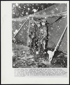 Mounties at Home in New York--Royal Canadian Mounted Police--C.R. Kvern, W. Frank and R.J. Oliver, left to right-- are surprised, but unconcerned, as the city acquires a blanket of cold, wet snow in an unexpected storm yesterday. The Mounties, here to take part in the National Horse Show at Madison Square Garden, stand outside tents erected for their use in a parking lot near the Garden.