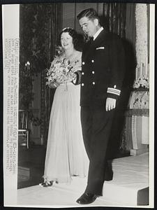 Muriel Vanderbilt Phelps Wed - Lieut. Comdr. John P. Adams steps from the altar with his bride, the former Muriel Vanderbilt Phelps, after their marriage here tonight.