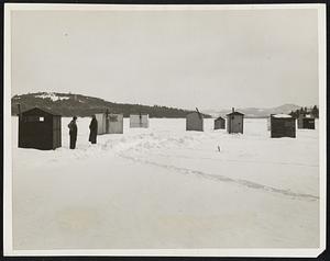 A section of the fishermens city built on the ice of Lake Winnipesaukee at Meredith. The fishermen spend their spare time in these houses fishing until the spring weather warms the ice to make it unsafe for holding them up. The houses are then removed to the lakes banks where they are stored away until next winter. It is estimated that the surface of the lake now has over a thousand of these little houses on it, and the fishermen report good catches.