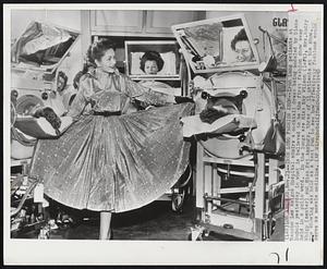 Iron Lung Fashion Show--Iron Lung patients at Rancho Los Amigos Hospital admire a cocktail dress being modeled by Diane DuBois yesterday in what is believed to be the first fashion show ever held in a polio ward. In the lungs are Miss Kay Wilson (left), Mrs. Audry Whipp (center) and Miss Pat Amsbury. three of 31 patients at the show. The showing was held as a test run to see how effectively fashions would serve as morale medicine.