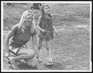 Smiling Happily over their successful kite flight are Mrs. Michele Roudebush of France and Cambridge, and Erika Naginski, 6, of Cambridge.