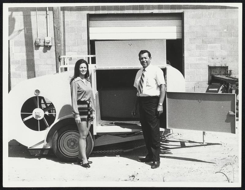 Looking for Work. Lubbock, Texas: N.A. Mattison, 43, poses with his "Litter Gitter," a machine he designed to take the backache out of picking up litter along the nation's highways. It sells for $3,950. On hand for the occasion is Dolores Salas, who is "Miss Lubbock."