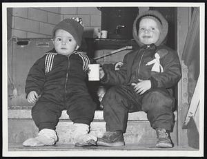 Have Some Soup--Dennis Cremins, 3, (right) of 19 Magna Rd., offers his brother, Michael, 1, cup of soup in Callahan School, West Lynn, where they sought shelter when heat failed in housing project.