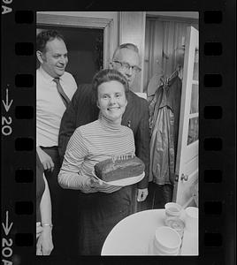 Woman holding cake with Mayor Byron Matthews on left