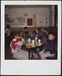 Group of boys having a snack at the table