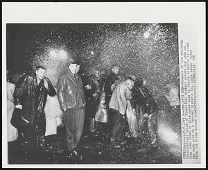 Syracuse, N.Y. -- Yes, It's Wet -- Pickets of the striking International Union of Electrical Workers scream and jeer as they take brunt of fire hoses used by deputy sheriffs to clear the main gate at a General Electric Co. plant here. Spray from the hoses douses area.