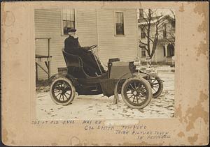 Man in early automobile in winter