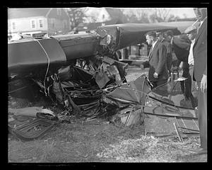 People examining a wrecked airplane