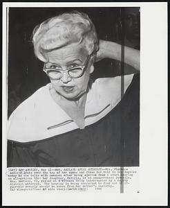Mrs. Aadland After Outburst--Mrs. Florence Aadland looks over the top her specs and fixes her hair in Los Angeles today as she talks with newsmen after being ejected from a court hearing on allegations that her daughter, Beverly, is an unsupervised juvenile. Mrs. Aadland, 53, yelled at a witness being interrogated by a deputy district attorney. The hearing is being conducted to find out if 17-year-old Beverly should be taken from her mother's custody.