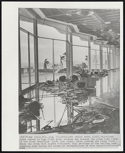 Hurricane Wrecks Hotel Lobby--Hurricane winds based in huge plate glass windows and wrecked the ocean view lobby of the plush Deauville Hotel last night. Water covered the lobby floor which was strewn with soaked furniture. Huge sections of the ceiling came crashing down during the storm.