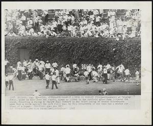 Kids, Attendants Clean Up Litter on Wrigley Field--Attendants at Wrigley Field, aided by kids from the stands, clean up litter in the outfield after fans littered the place, following a ruling by Umpire Bill Stewart in the third inning of second Cubs-Braves game that a drive against the left field wall by Phil Cavaretta of the Cubs was a double instead of a homer.