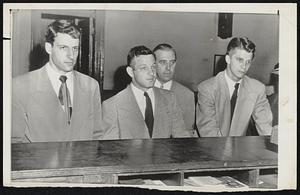 Bradley Basketball Players Booked-Left to right, George M. Chianakas, Eugene Metchioree and William K. Mann, Bradley University hoopsters booked at Elizabeth street police station in New York for accepting bribes. In background is Detective James Canavan.