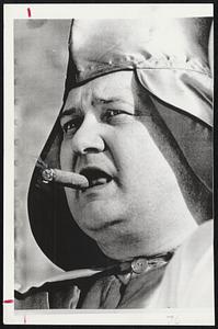 A Roll of his Cigar with his tongue by member of Ku Klux Klan as he listens to speakers at KKK rally in Morgantown, N. C. The Klan’s Imperial Wizard, Robert Shelton, described President Johnson as a “megalomaniac” as he spoke to about 600