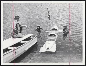 "Prepare to Submerge"--Survival instructor Thomas C. O'Donnell of Dracut is about to send down divers Arthur Geddes, left, and Donald J. Conroy, both of Lowell, during water survival session on Mirror Lake, Ford Devens.