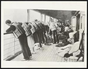 As First Lifeboat Left Dixie With life preservers strapped about them, passengers line the rail of the grounded Morgan liner Dixie Sept. 4 towatch the first lifeboat lowered and safely launched as the boat tossed on French reef off this coast. Their turn came next--all were saved. Meanwhile, the life belts gave a feeling of security.