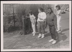Group of four on the sidewalk
