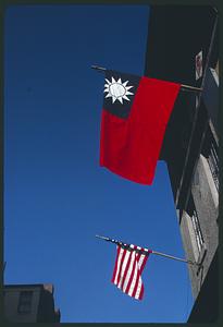 American flag and flag of the Republic of China projecting from exterior building wall