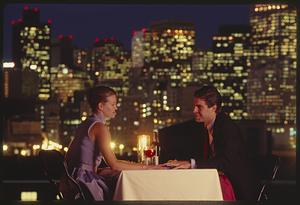 Romantic dinner with ring against the backdrop of the Boston skyline