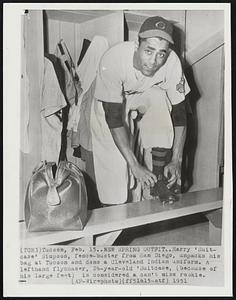 New Spring Outfit.. Harry 'Suitcase' Simpson, fence-buster from San Diego, unpacks his bag at Tucson and dons a Cleveland Indian uniform. A lefthand flychaser, 26-year-old 'Suitcase, (because of his large feet) is considered a can't miss rookie.