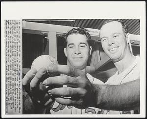 Milwaukee – It Was A Ball – Milwaukee Braves pitcher Wade Blasingame and third baseman Eddie Mathews pose with the game ball in the dressing room at County Stadium last night after Blasingame’s one-hitter and Mathews’ grand slam home run against the New York Mets. Blasingame beat former Braves pitcher Warren Spahn who was making his first start against his old teammates. Mathews’ homer in the fifth inning was the seventh grand slammer of his career and his 453rd home run.