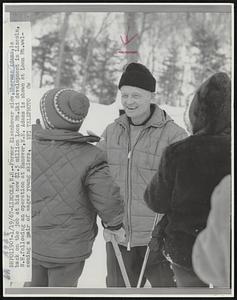 Former Eisenhower aide, Sherman Adams, is back on the job at his new $1.5 million Loon Mt. Ski development in Lincoln, N.H. following an operation at Hanover, N.H. Adams is shown at Loon Mt. welcoming a pair of eager young skiers.