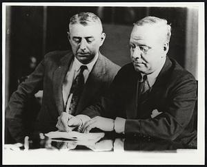 Mayor Nichols affixing his signature to the document which makes the East Boston tunnel a certainty following the acceptance of the legislative act by the City Council Tuesday. President Timothy J. Donovan of the City Council is witnessing the Mayor's signature.
