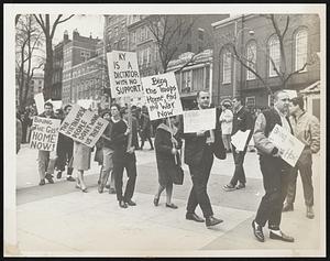 Anti-Vietnam Marchers-A demonstration on Boston Common Saturday by 60 chanting picketers was cut short when a half-dozen eggs showered upon them from a group of high-school-age hecklers waving American flags. Police escorted the marchers into the subway and dispersed the crowd but four were later attacked on the Common.