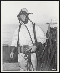 Shallow Water Diving. SFC Neil A. Erikson attired in a shallow water diving mask and suit prepares to submerge for checking pilings at a U.S. army transportation corps port facility, Yokohama, Japan.