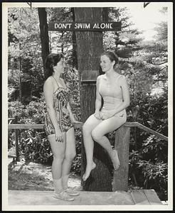 Swim With a Buddy-That's another way of putting the warning on the sign above Ann Wasilauskas of Brighton and Barbara Bocanfuso of Wollaston.