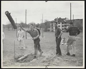 Tossing The Caber up-country style. A Colby College "pulp thrower" watches his log in flight. An old Scottish custom.