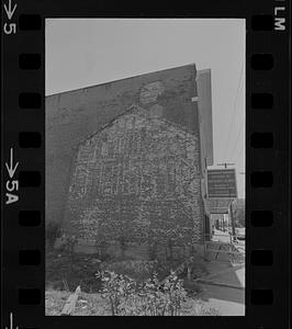 Outline of an old building on a brick wall