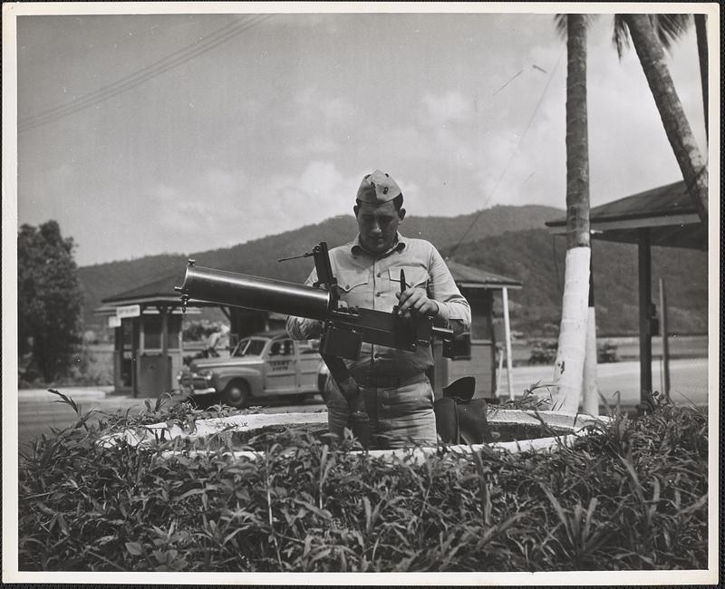 Private Willie A. Wilson of Ealsey, South Carolina carries out his duty of making sure that the 30 caliber machine gun is ready for any emergency