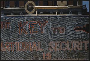 Parade float reading "The key to national security is," Boston