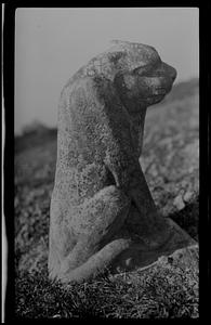 Stone animal carving in field