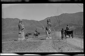 Statues with animals, people, and cart