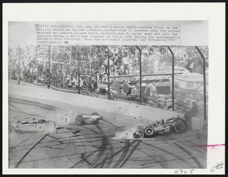 Multi-Racer Crash - Debris flies in the air, top center, as Gordon