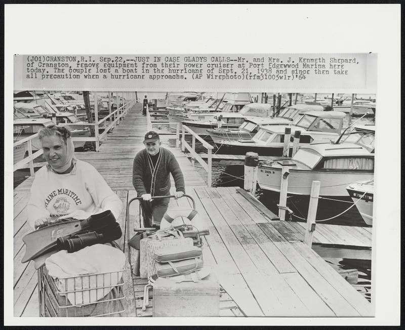 Just in Case Gladys Calls--Mr. and Mrs. J. Kenneth Shepard, of Cranston, remove equipment from their power cruiser at Port Edgewwod Marina here today. The couple lost a boat in the hurricane of Sept. 21, 1938 and since then take all precaution when a hurricane approachs.