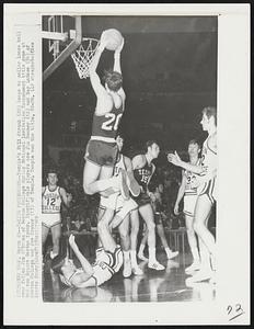 Taking Possession -- Temple's Bill Strunk (20) leaps to collar loose ball over fallen Jim O'Brien of Boston College during National Invitation Tournament title game at Madison Square Garden today. Identifiable players are Jim Downey (12) and Ray Lagace (34) of Boston College and Joe Cromer